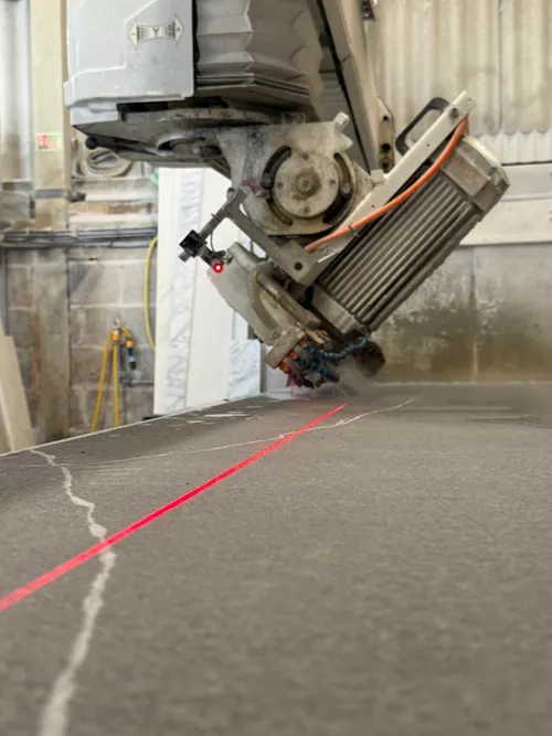 CNC bridge saw cutting stone in the In2stone fabrication workshop