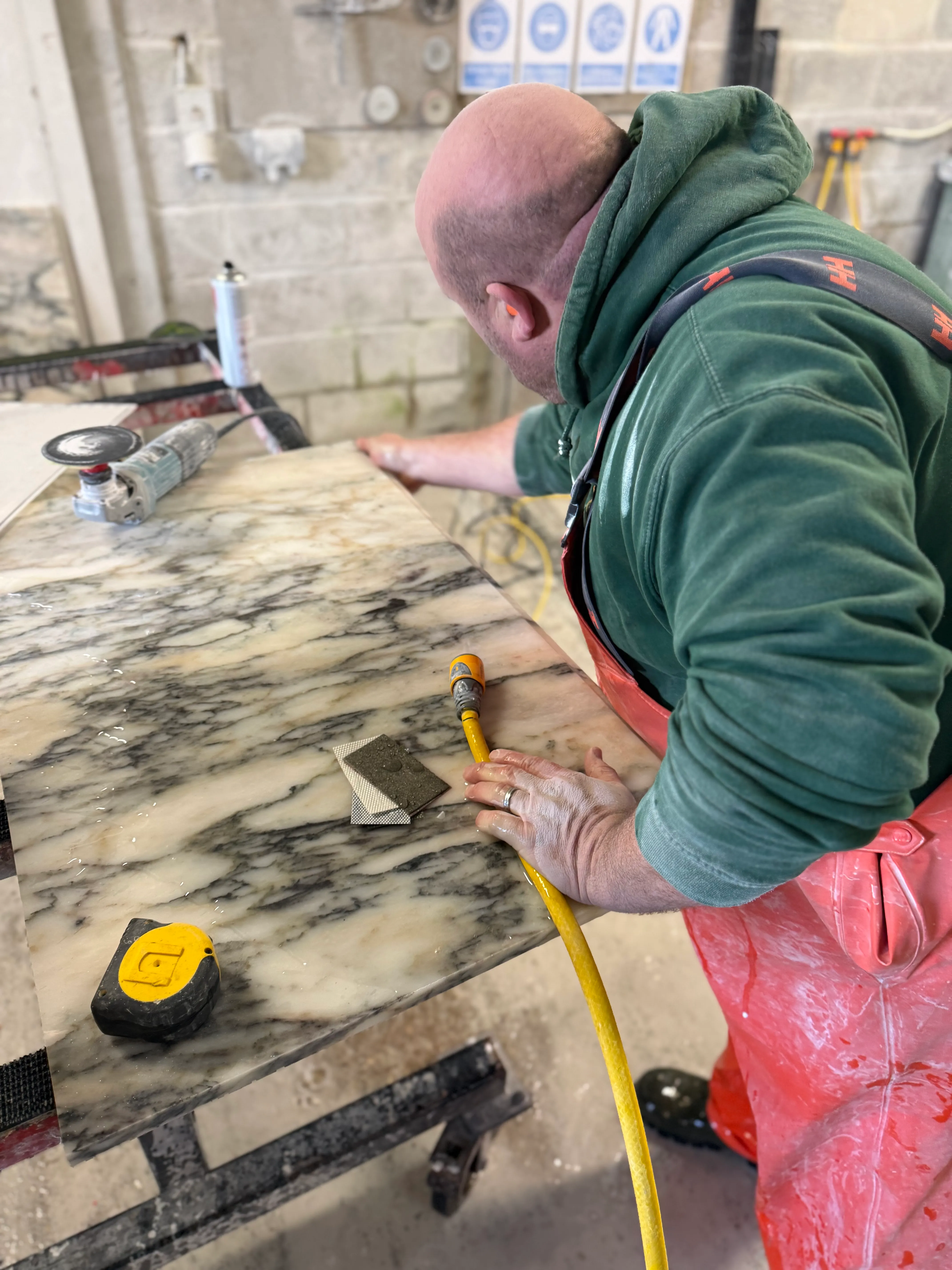 Hand-polishing a marble surface in the In2stone workshop
