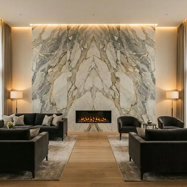 Dramatic floor-to-ceiling book-matched marble feature wall with contemporary inset fire in a modern British living room