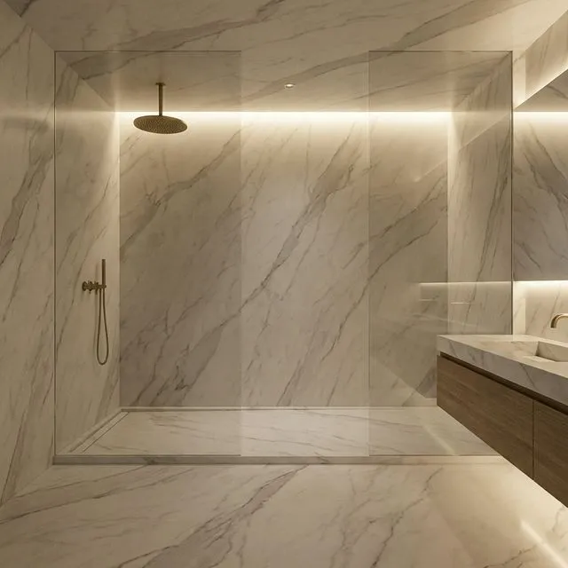 Luxury stone wet room with full-height calacatta marble-effect panels, frameless glass screen, and brushed brass rainfall shower