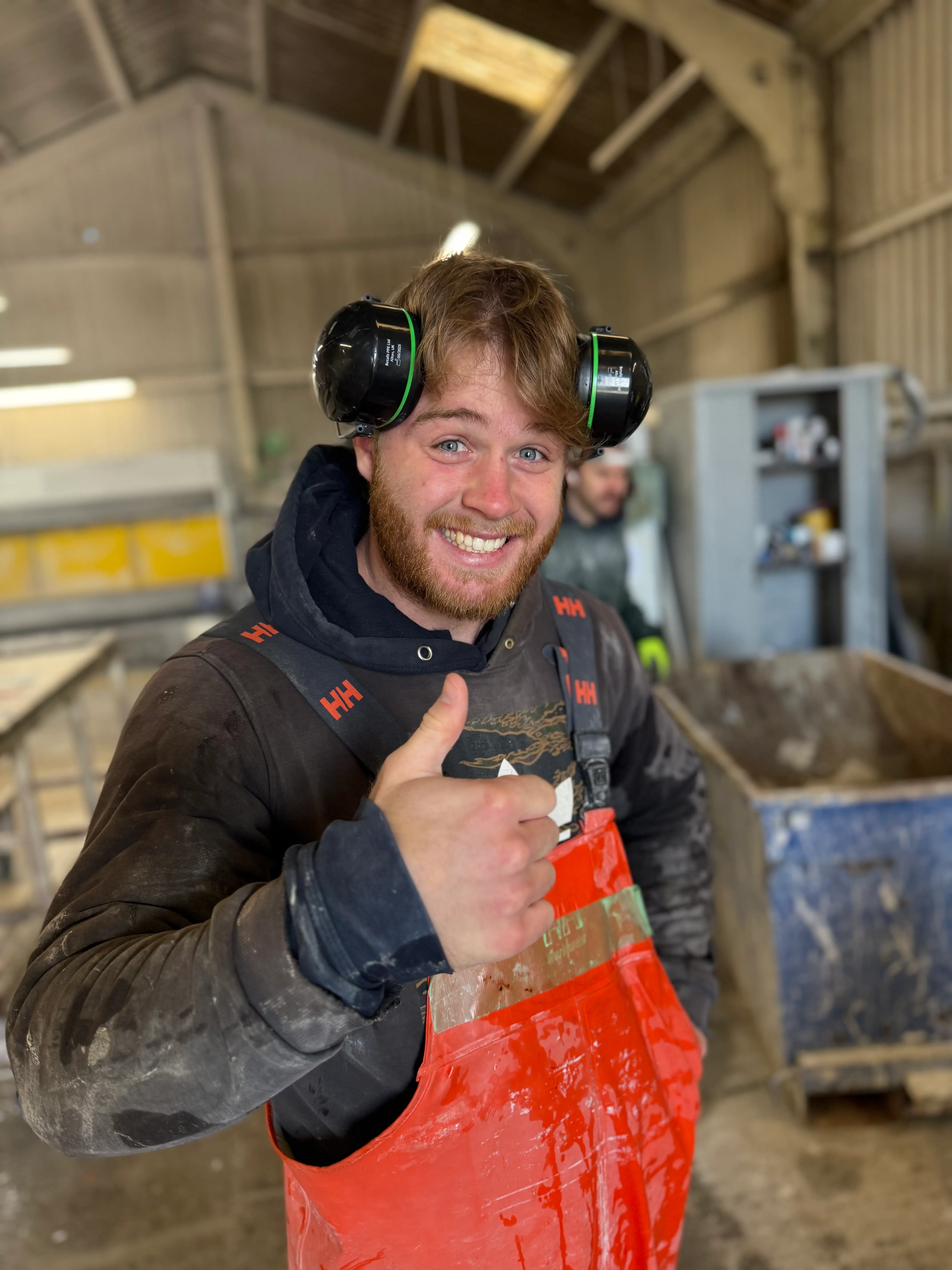 In2stone team member giving thumbs up in the workshop